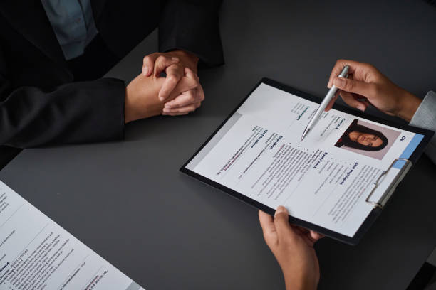 High angle view of specialist asking questions to applicant at meeting
