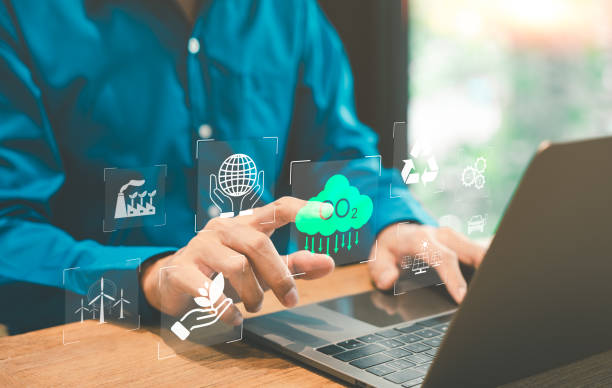Sustainable Development and Carbon Footprint Analysis Concept. Carbon Neutrality, A man using a laptop with icons representing sustainability, CO2 emissions, and environmental management strategies.